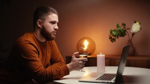 Side View of Happy Handsome Man Enjoying Distant Dating Using Laptop Computer Clinking Champagne