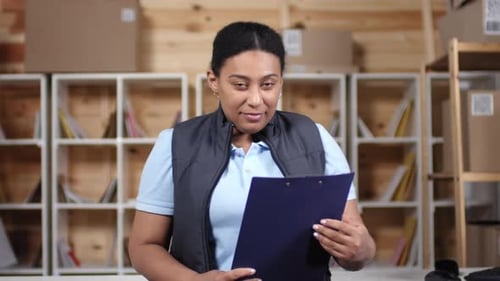 African American Woman Posing for Camera at Work in Post Office