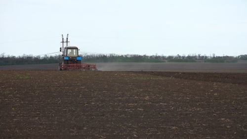 Tractor plows the farm field