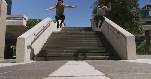 Men Perform Acrobatic Stunts on Urban Stairs