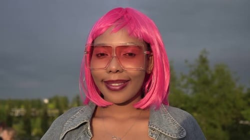 Woman with Pink Hair Smiling Outdoors