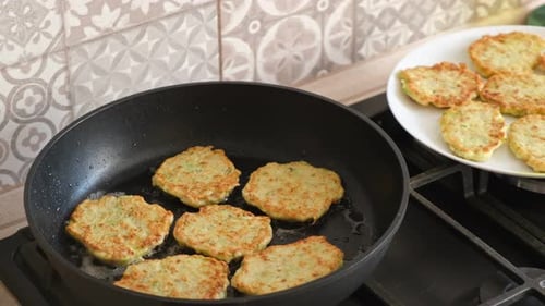 Fritters Cooking in a Pan Inside of Kitchen