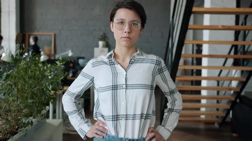 Portrait of Confident Girl Entrepreneur Standing in Coworking Office Looking at Camera