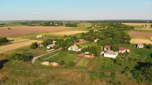 Aerial View of the Countryside and Small Village with Green Fields and Meadows