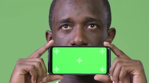 Adult Holds Phone with Green Screen for Chroma Key
