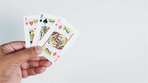 Hand Holds Kings Playing Cards in Close Up