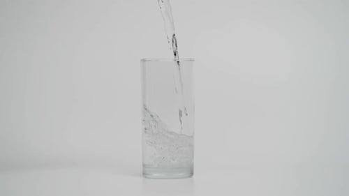 Water Being Poured Into Clear Glass