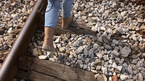 Scene of female walk on old train rails in slow motion 1080p FullHD footage - Casual clothed woman