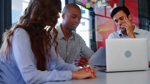 Team Discusses Business in Modern Office