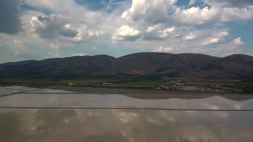 Alykes the Hellenic saltworks located outside of Mesolongi in Greece. Drone footage with the clouds
