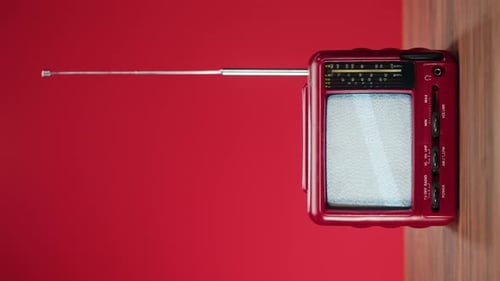 Vintage Red Television with Static Screen on Table