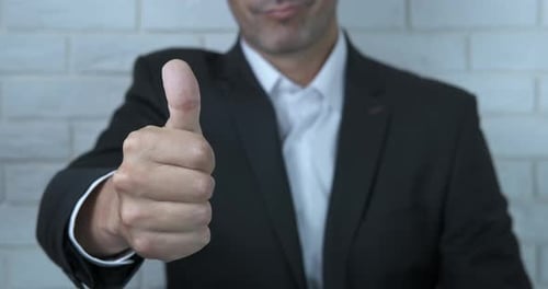 Man in Suit Giving Thumbs Up Close Up
