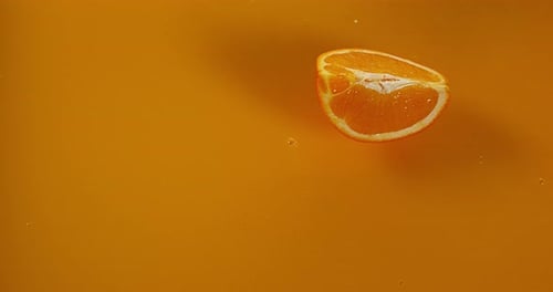 Orange, citrus sinensis, Fruit falling into Orange Juice, Slow Motion 4K
