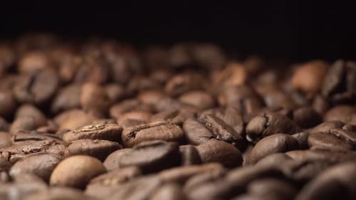 Super Extreme Close Up Footage of Coffee Beans with Black Background on the Table with Black