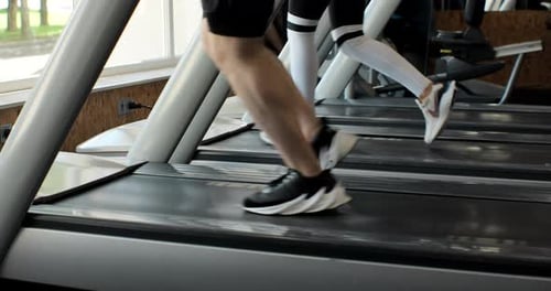 Athletic People Running on Treadmills Doing Fitness Exercise
