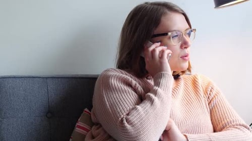 Woman Talking on Phone While Sitting Indoors