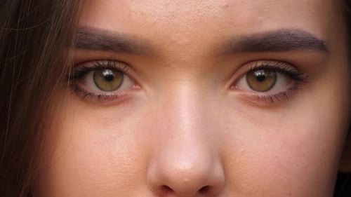 A close up portrait of beauty young beautiful woman's eyes, smiling looking at camera. 4 k. Eyes of