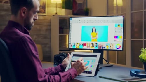 Man Editing Photos on Tablet at Home Office