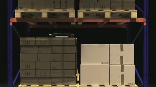 Forklift with a stack of cardboard boxes on a wooden pallet in the warehouse.