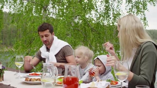 Family Meal Outdoors By the Forest