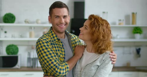 Loving Couple Embracing in Modern Kitchen