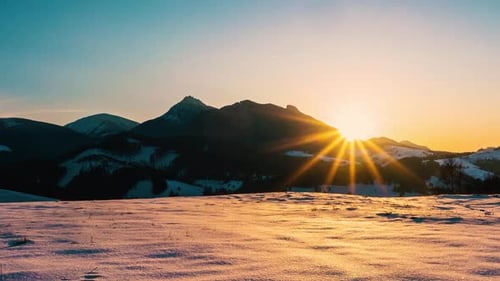 Winter Sunrise over Snowy Mountain Landscape