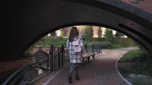 Attractive Girl of European Appearance Walks Down the Street Smiling