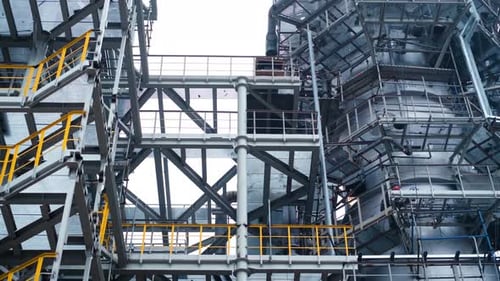 Work shift at the factory: welding. Sparks from welding machine fall from above.