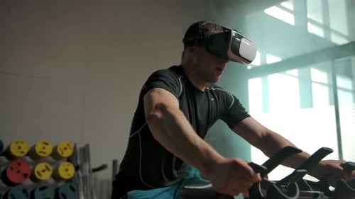 Man Works Out With Virtual Reality Headset on Bike