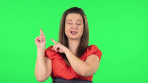 Portrait of Cute Girl Pointing Fingers for Something with Copy Space. Green Screen