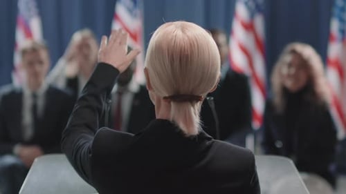 Woman Giving Speech with Audience Standing Ovation