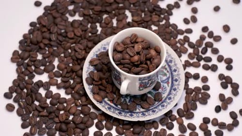 Roasted Coffee Beans with Cup on White Background