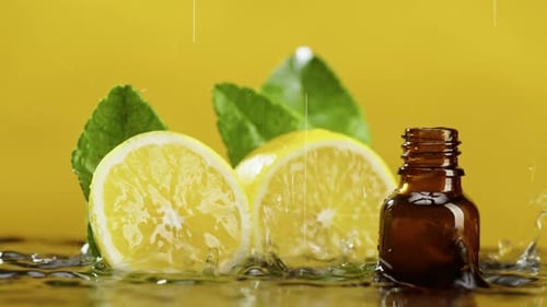 Lemon Slices and Essential Oil with Water Droplets