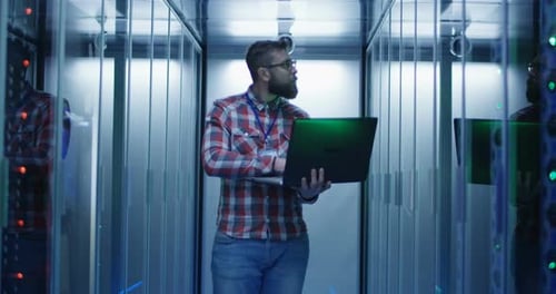 Adult Man Works in Modern Server Room