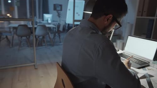 Middle Eastern Architect Drawing Construction Plan at Office Desk