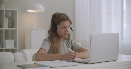 Girl Studying Online with Laptop and Headset