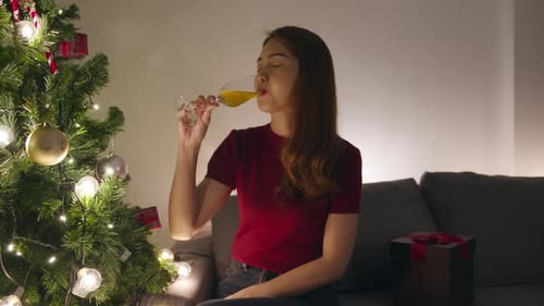 Woman Toasting Champagne Glass at Christmas Time