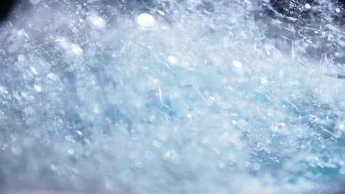 Blue color bubbles macro in rotating for background and design.