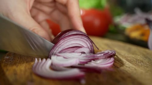 Slicing Red Onion on Wooden Cutting Board