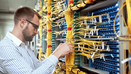 Man Works with Yellow Server Cables