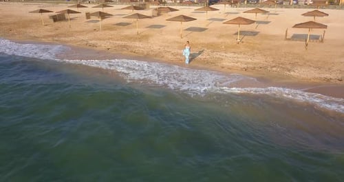 girl on the beach in a dress near the sea