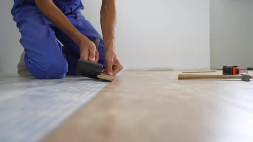 A Man Professional Laminate Installer Laying Laminate Wood