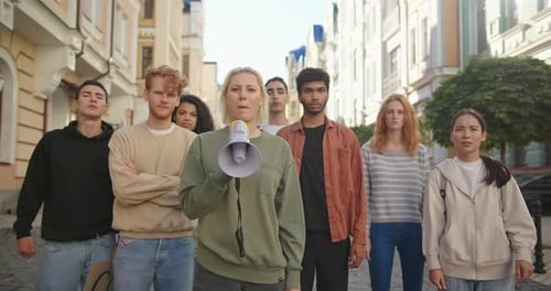 Group Protests with Megaphone on City Street