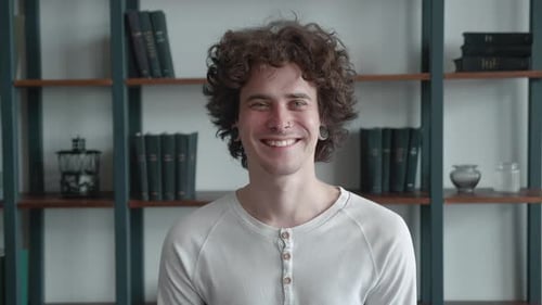 Young Millennial with Pierced in the Nose Handsome with Ears Tunnels and Smiling Joyfully of Library