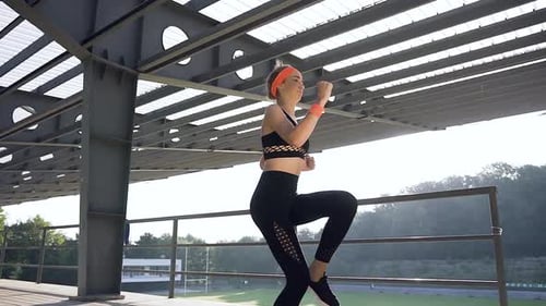Woman Doing High Knee Exercise Outdoors During the Day