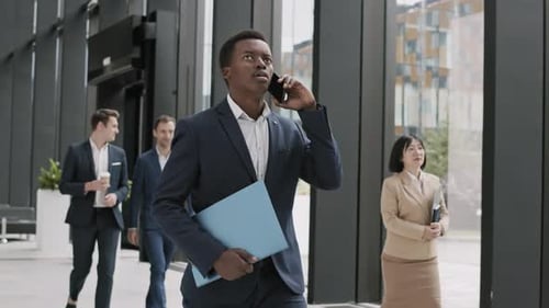 Busy Professionals Walking in Modern Office Building