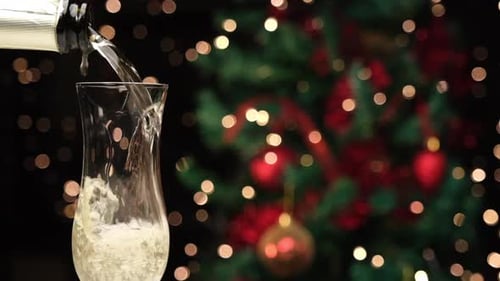 Champagne Pouring into Glass with Christmas Tree