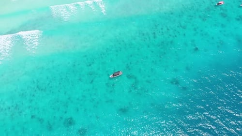 Aerial View of Fishing Boats Swaying on the Waves Off a Paradise Beach Zanzibar