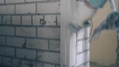 Worker Plastering a Brick Wall Indoors