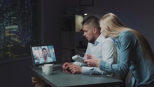 Business Colleagues Video Conferencing Late at Night